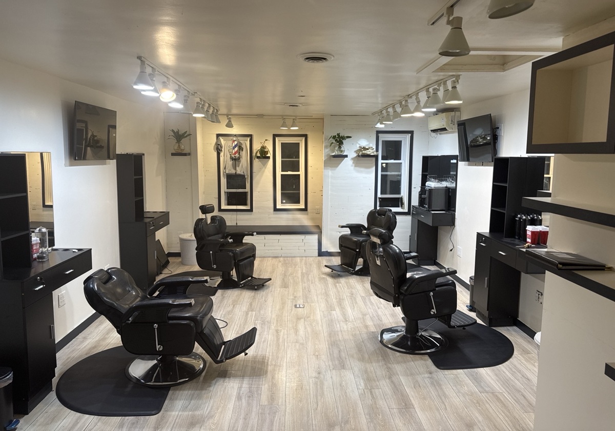 Barbershop full interior view — newly constructed layout with professional lighting
